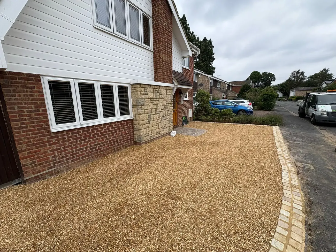 Gravel driveway with block-paved edging in front of a house in Surrey