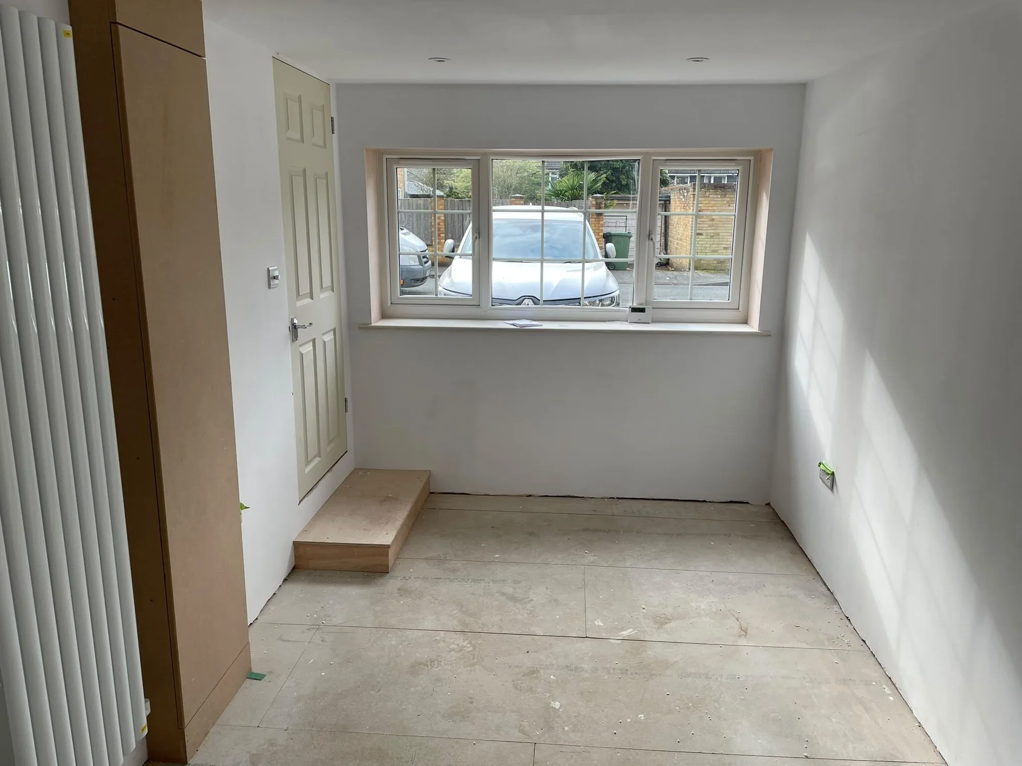 Converted garage finished as a bright room with a new window and freshly plastered walls in Surrey