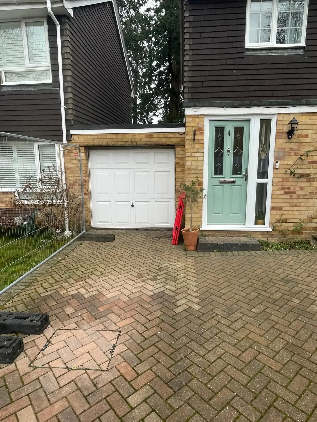 House exterior with the original up-and-over garage door before the conversion began